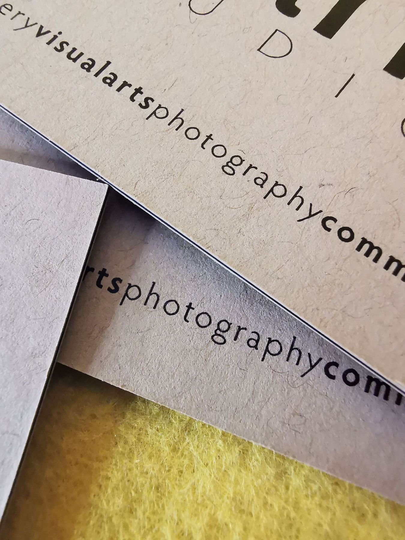 Close-up of textured business cards printed with a website address