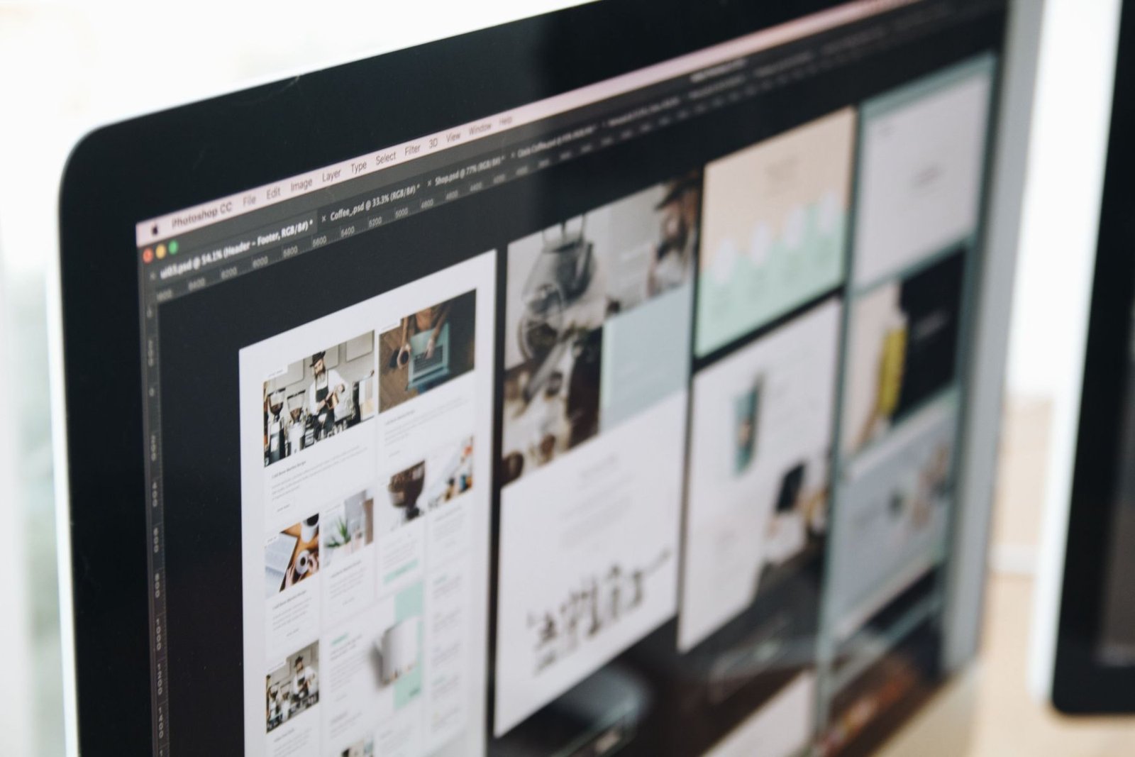 Close-up of a screen showing website page designs being edited