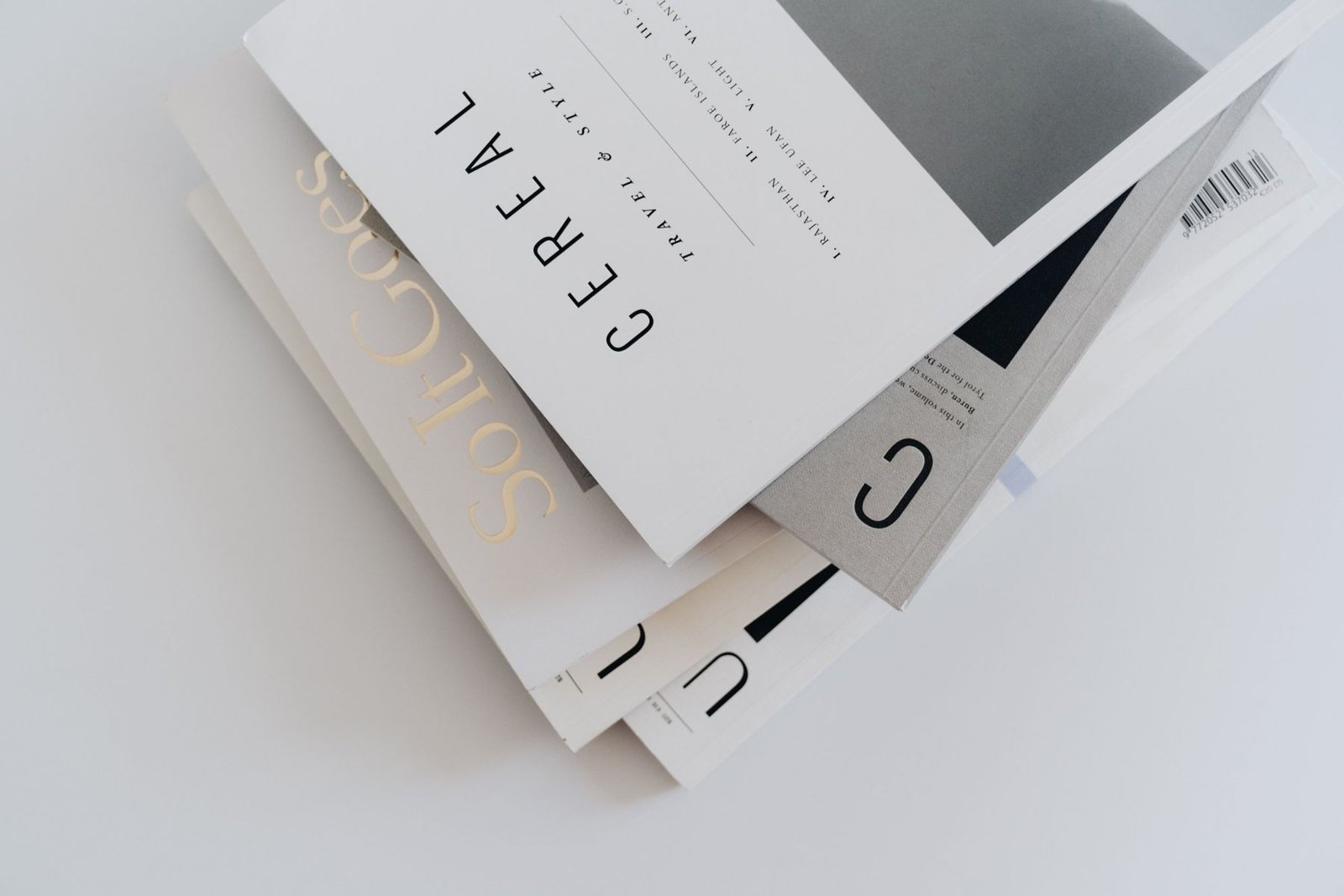 A stack of independent magazines with clean, simple typography
